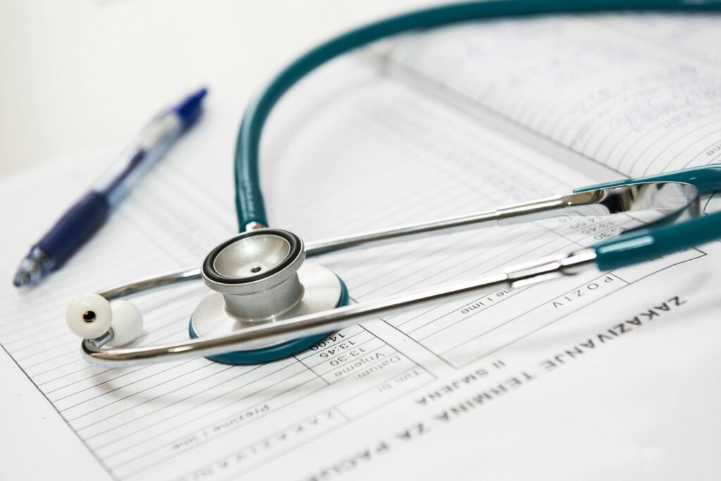 Why Medical Billing Errors Quietly Drain Practice Revenue and How to Stop Them A stethoscope and pen resting on a medical report in a healthcare setting.